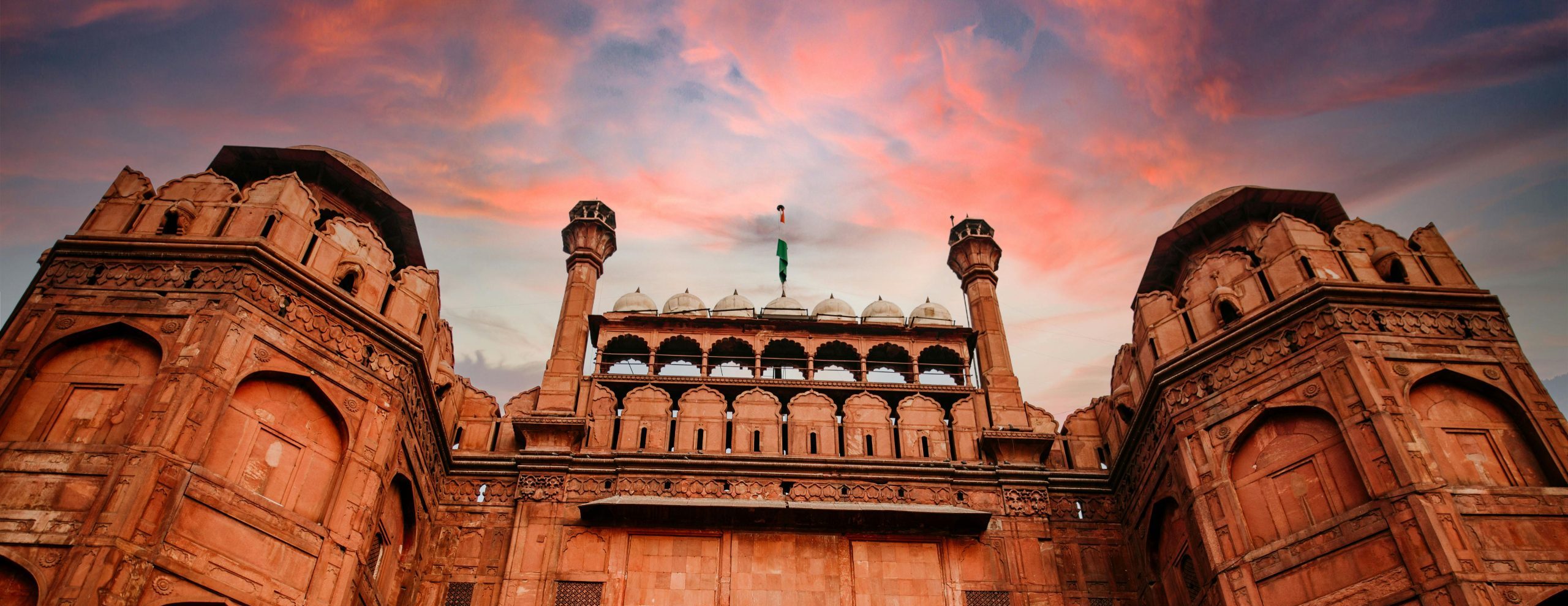 Stunning low angle shot of The Red Fort in New Delhi with a dramatic sky.